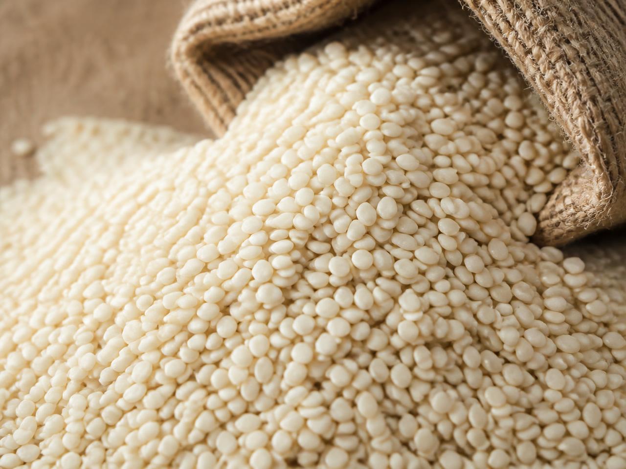White sesame seeds spilling from a jute sack